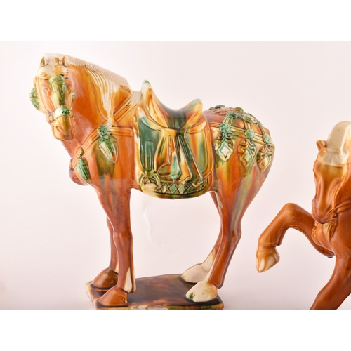 239 - A pair of Chinese Tang Dynasty Sancai style glazed ceramic war horses, 20 cm high.