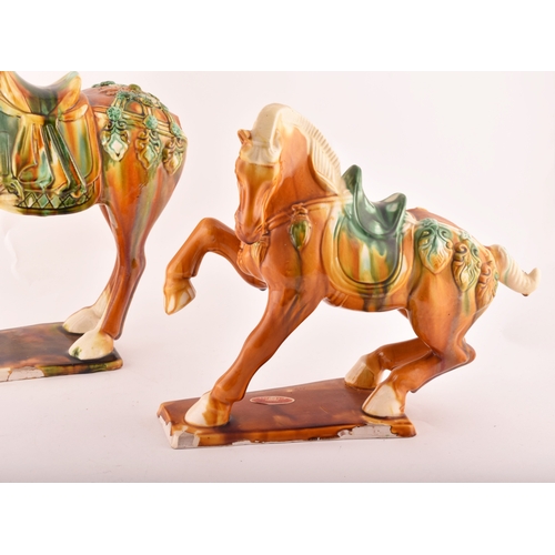 239 - A pair of Chinese Tang Dynasty Sancai style glazed ceramic war horses, 20 cm high.