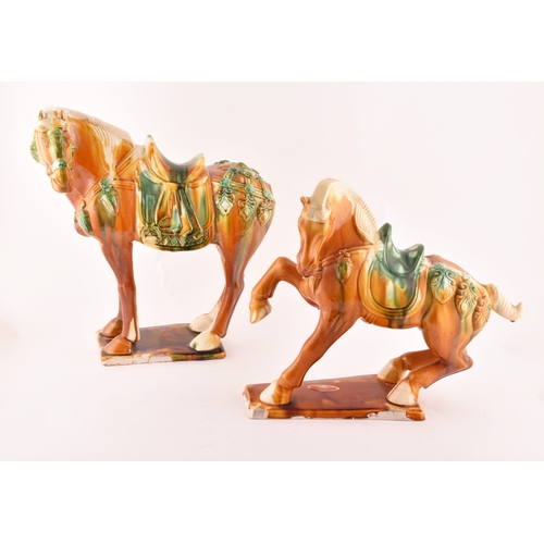 239 - A pair of Chinese Tang Dynasty Sancai style glazed ceramic war horses, 20 cm high.