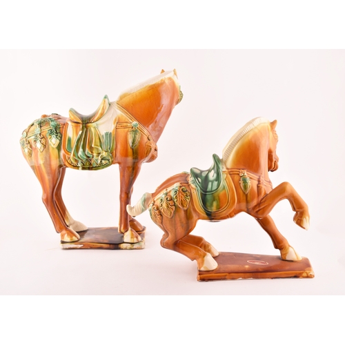 239 - A pair of Chinese Tang Dynasty Sancai style glazed ceramic war horses, 20 cm high.