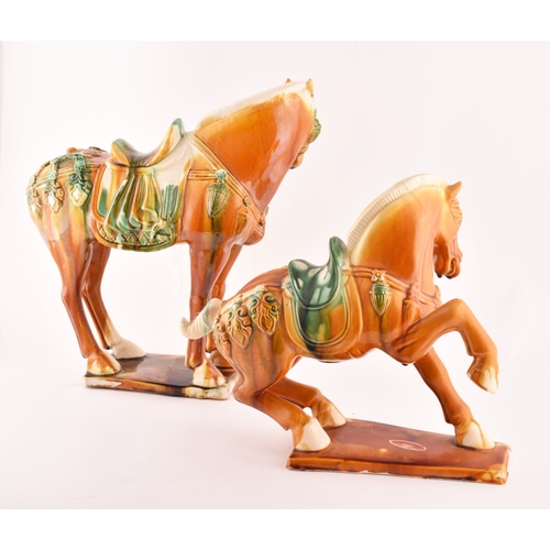 239 - A pair of Chinese Tang Dynasty Sancai style glazed ceramic war horses, 20 cm high.