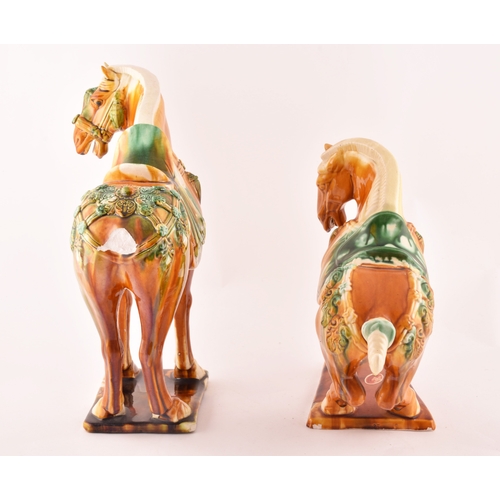 239 - A pair of Chinese Tang Dynasty Sancai style glazed ceramic war horses, 20 cm high.