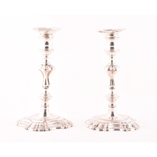 181 - A pair of George II silver candlestick holders, ornately decorated, hallmarked London, possibly 1748... 