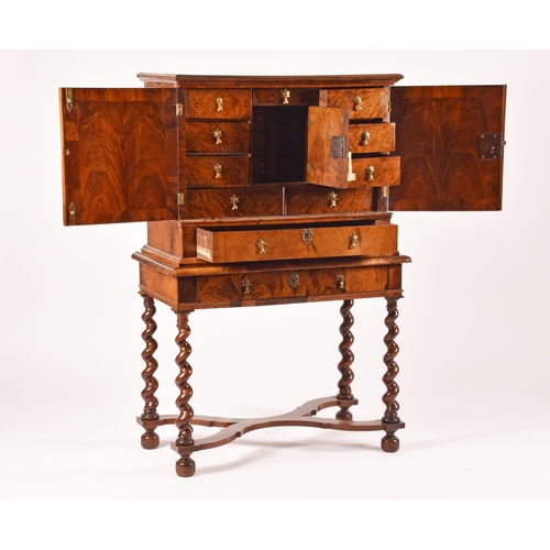 274 - An early 18th century William and Mary figured walnut chest on stand, the top with a pair of doors w... 