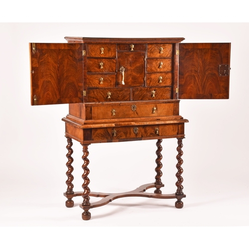 274 - An early 18th century William and Mary figured walnut chest on stand, the top with a pair of doors w... 