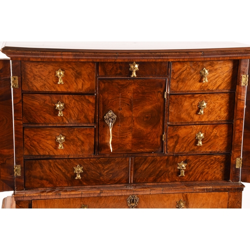 274 - An early 18th century William and Mary figured walnut chest on stand, the top with a pair of doors w... 