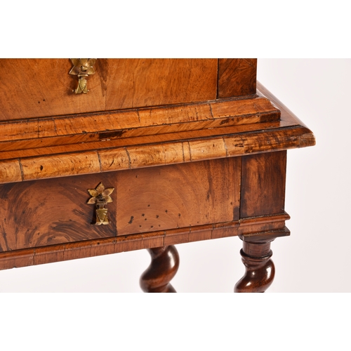 274 - An early 18th century William and Mary figured walnut chest on stand, the top with a pair of doors w... 