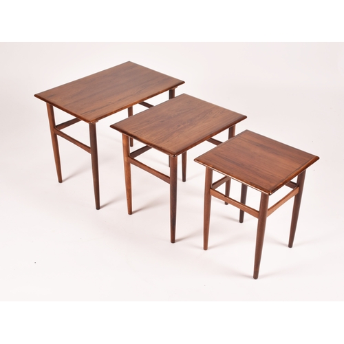 295 - A Danish Dyrlund rosewood nest of three tables, the crossbanded tops with moulded edges and supporte... 