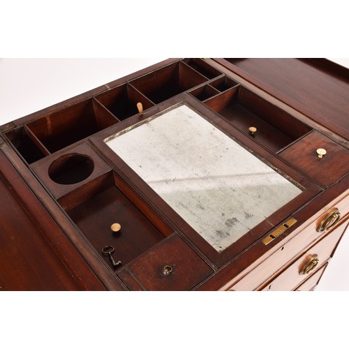 297 - A George III mahogany dressing chest, the top with a pair of flaps opening to reveal a fitted interi... 