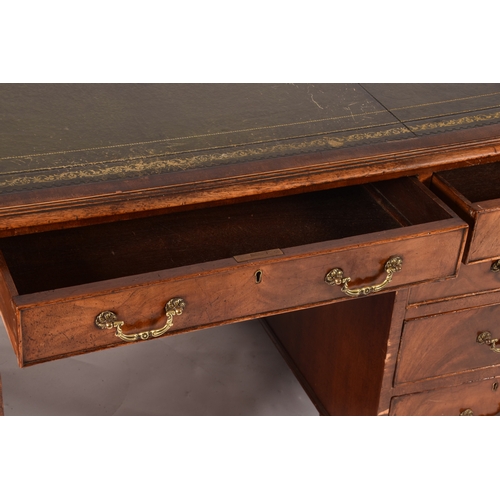 299 - A large mahogany pedestal desk, the green gilt tooled leather top over three frieze drawers, wit thr... 