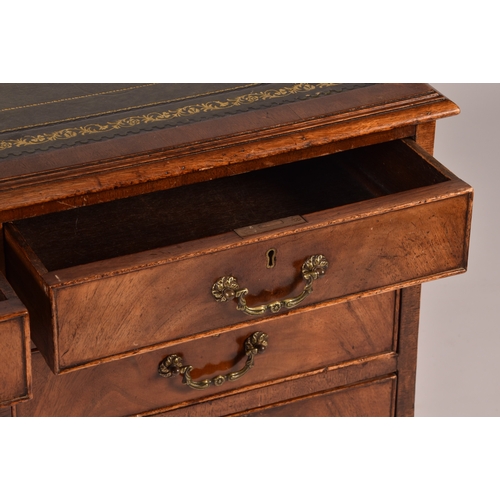 299 - A large mahogany pedestal desk, the green gilt tooled leather top over three frieze drawers, wit thr... 