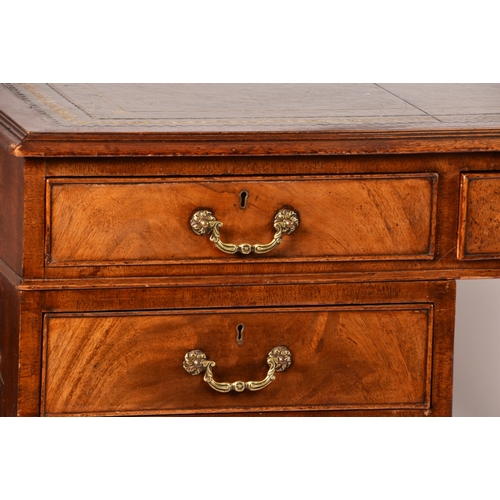 299 - A large mahogany pedestal desk, the green gilt tooled leather top over three frieze drawers, wit thr... 