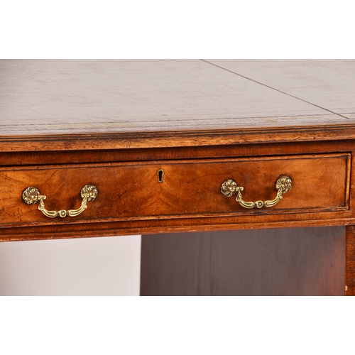 299 - A large mahogany pedestal desk, the green gilt tooled leather top over three frieze drawers, wit thr... 