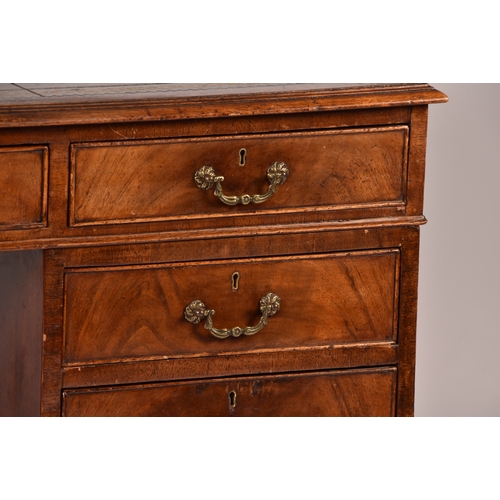 299 - A large mahogany pedestal desk, the green gilt tooled leather top over three frieze drawers, wit thr... 