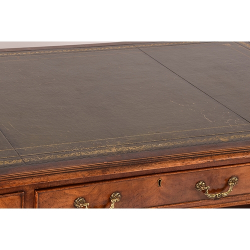 299 - A large mahogany pedestal desk, the green gilt tooled leather top over three frieze drawers, wit thr... 