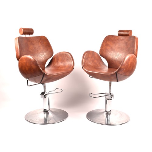 301 - A pair of Chloe tan leather styling / barber chairs, height adjustable, each with scallop shaped sea... 