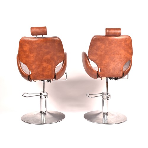 301 - A pair of Chloe tan leather styling / barber chairs, height adjustable, each with scallop shaped sea... 