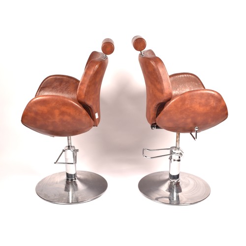 301 - A pair of Chloe tan leather styling / barber chairs, height adjustable, each with scallop shaped sea... 