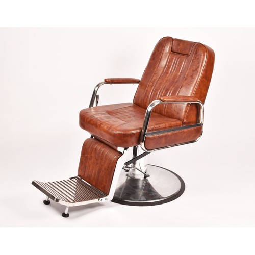 302 - A Nicholas tan leather barber chair, height adjustable, with reclining back and head rest, supported... 