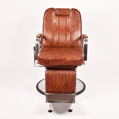 302 - A Nicholas tan leather barber chair, height adjustable, with reclining back and head rest, supported... 