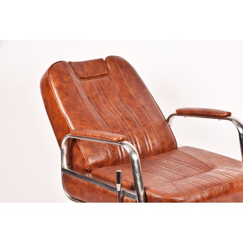 302 - A Nicholas tan leather barber chair, height adjustable, with reclining back and head rest, supported... 