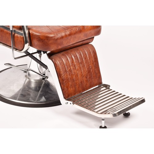 302 - A Nicholas tan leather barber chair, height adjustable, with reclining back and head rest, supported... 