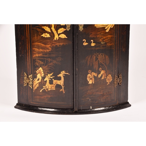 309 - An 18th century Chinoiserie decorated bow fronted corner cupboard, the pair of doors decorated with ... 