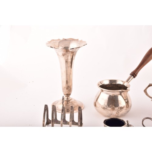 199 - A group of assorted silver items, including a brandy pan, a silver cup, condiment sets, toast rack, ... 