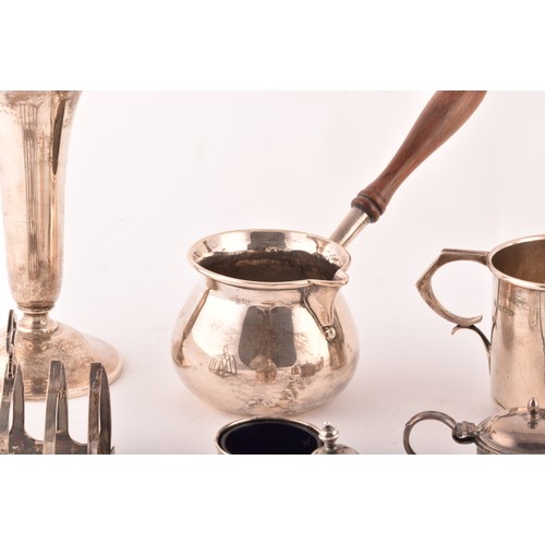 199 - A group of assorted silver items, including a brandy pan, a silver cup, condiment sets, toast rack, ... 