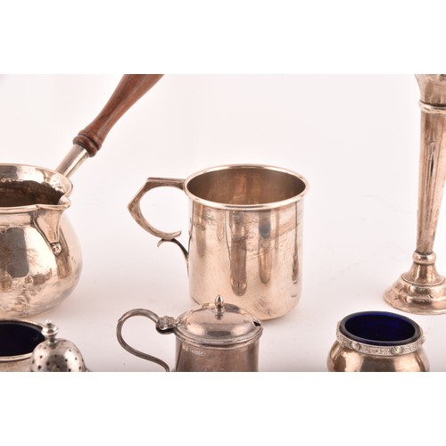 199 - A group of assorted silver items, including a brandy pan, a silver cup, condiment sets, toast rack, ... 