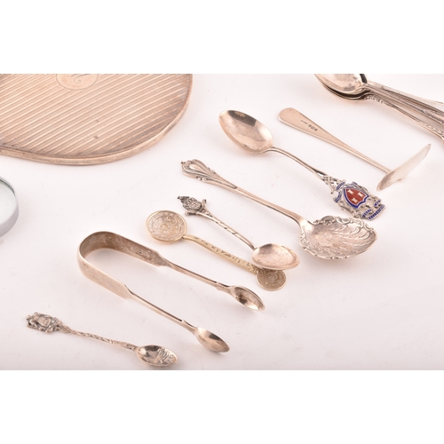 200 - A collection of assorted silver items, including several teaspoons, sugar cube tongs, hand held mirr... 