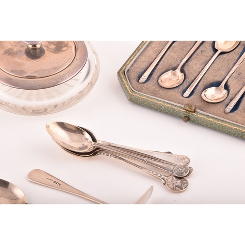 200 - A collection of assorted silver items, including several teaspoons, sugar cube tongs, hand held mirr... 