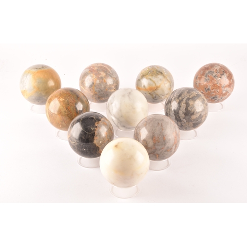 333 - A group of ten specimen marble spheres on stands, each approximately 9cm diameter. (10)