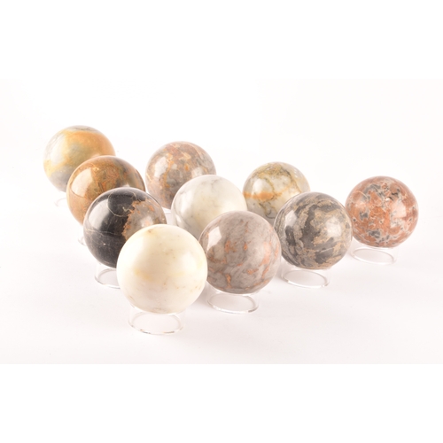 333 - A group of ten specimen marble spheres on stands, each approximately 9cm diameter. (10)