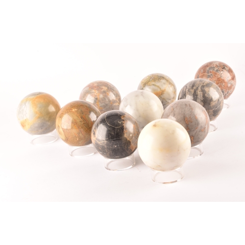 333 - A group of ten specimen marble spheres on stands, each approximately 9cm diameter. (10)