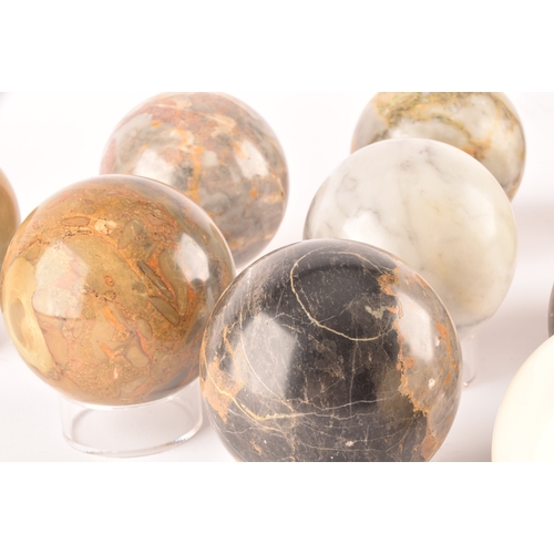 333 - A group of ten specimen marble spheres on stands, each approximately 9cm diameter. (10)