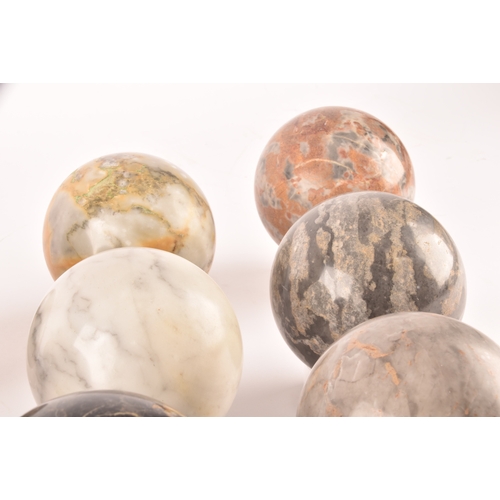 333 - A group of ten specimen marble spheres on stands, each approximately 9cm diameter. (10)