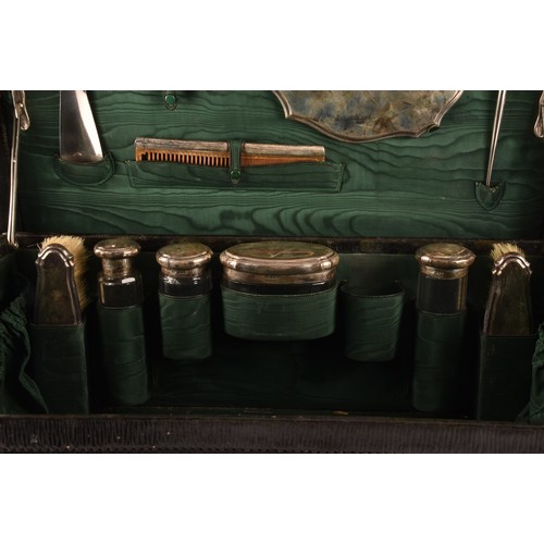 201 - A travelling leather suitcase, with fitted silver interior, inlaid with green material, by Goldsmith... 