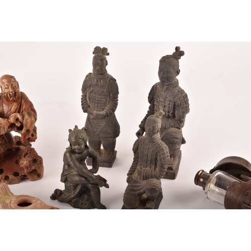 132 - A collection of decorative items including copies of the terracotta warriors, a silver topped flask ... 