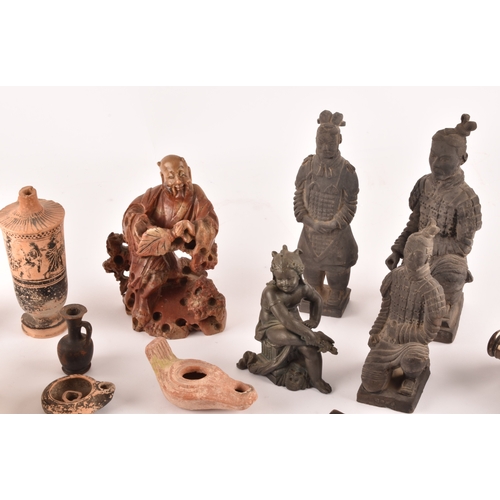 132 - A collection of decorative items including copies of the terracotta warriors, a silver topped flask ... 