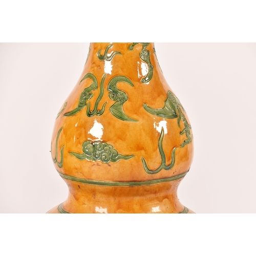 243 - A very large pair of Chinese yellow glazed doubled gourd garden vases, decorated in green with bats ... 