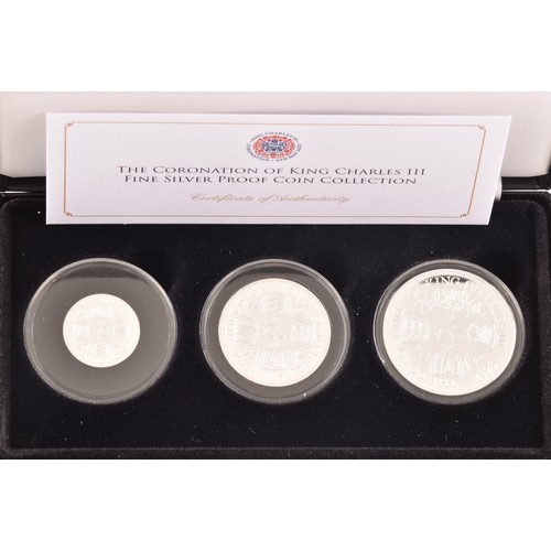 148 - A collection of silver commemorative coin sets including: The Coronation of King Charles III fine si... 