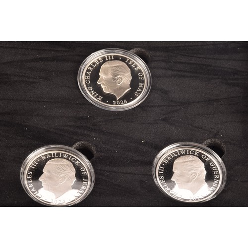 148 - A collection of silver commemorative coin sets including: The Coronation of King Charles III fine si... 