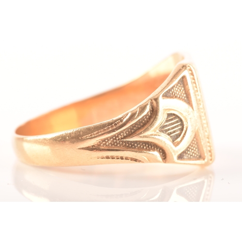 27 - An 18ct yellow gold signet ring, with engraved initials and carved detailing to shoulders, size T, a... 