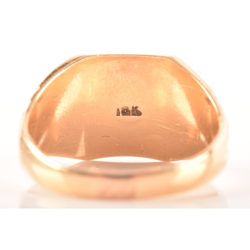 27 - An 18ct yellow gold signet ring, with engraved initials and carved detailing to shoulders, size T, a... 