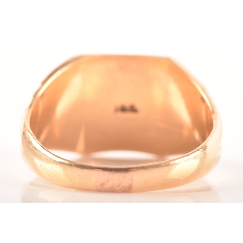 27 - An 18ct yellow gold signet ring, with engraved initials and carved detailing to shoulders, size T, a... 