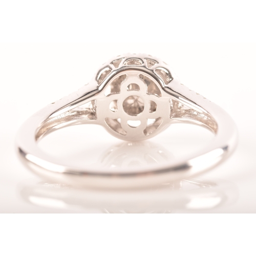 29 - An 18ct white gold diamond round cluster ring, set to centre with a cluster of brilliant cut diamond... 