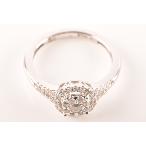 29 - An 18ct white gold diamond round cluster ring, set to centre with a cluster of brilliant cut diamond... 