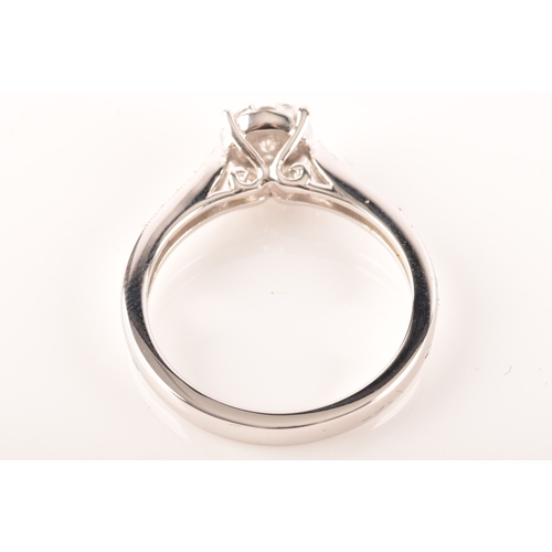 33 - An 18ct white gold diamond solitaire cluster, set to centre with a brillaint cut diamond with an app... 