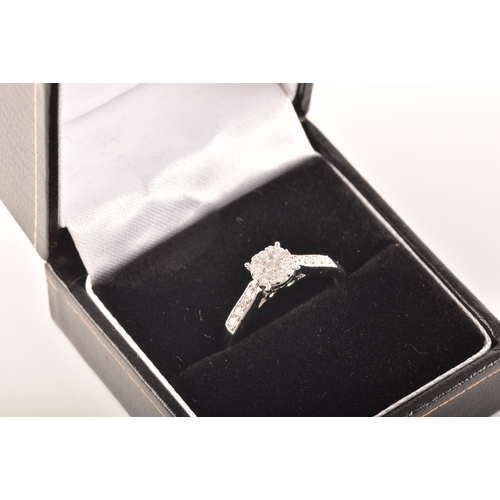 33 - An 18ct white gold diamond solitaire cluster, set to centre with a brillaint cut diamond with an app... 